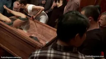 Public slut in wooden glass box
